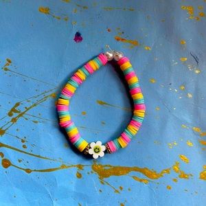 This is a yellow blue and pink with a flower on in the middle fits 8-13 years